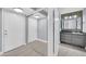 Inviting hallway featuring tile floors, neutral colors, and modern lighting at 3825 E Camelback Rd # 182, Phoenix, AZ 85018