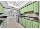 The kitchen features updated stainless appliances, stone countertops and bright green cabinets at 3825 E Camelback Rd # 182, Phoenix, AZ 85018