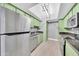 The kitchen features updated stainless appliances, stone countertops and bright green cabinets at 3825 E Camelback Rd # 182, Phoenix, AZ 85018