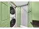 Convenient laundry room featuring a stackable washer and dryer and ample cabinet space at 3825 E Camelback Rd # 182, Phoenix, AZ 85018