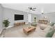 Open-concept living room and dining area featuring hardwood floors, modern furniture, and ceiling fans at 3825 E Camelback Rd # 182, Phoenix, AZ 85018