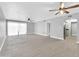 Open living area with luxury vinyl flooring, access to the kitchen, and sliding glass doors at 3825 E Camelback Rd # 182, Phoenix, AZ 85018