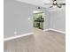 Bright living room featuring luxury vinyl flooring leading into a green kitchen at 3825 E Camelback Rd # 182, Phoenix, AZ 85018