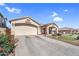 Inviting single-story home with desert landscaping, a spacious driveway, and a welcoming entrance at 38771 N Dena Dr, San Tan Valley, AZ 85140
