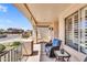 Relaxing covered porch with comfortable seating and a neighborhood view at 38771 N Dena Dr, San Tan Valley, AZ 85140