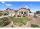 Charming single-story home boasts a well-manicured lawn, desert landscaping, and a welcoming covered front porch at 38771 N Dena Dr, San Tan Valley, AZ 85140