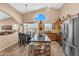 Bright kitchen featuring stainless steel appliances, center island with bar seating and an adjacent dining area at 38771 N Dena Dr, San Tan Valley, AZ 85140