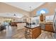Open-concept kitchen boasts stainless steel appliances, granite countertops, and seamless flow into a cozy living area at 38771 N Dena Dr, San Tan Valley, AZ 85140