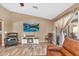 Relaxing living room featuring a TV, cozy fireplace, comfortable seating, and backyard access at 38771 N Dena Dr, San Tan Valley, AZ 85140