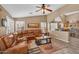 Spacious living room featuring vaulted ceilings, stylish shutters, and a comfortable leather sectional at 38771 N Dena Dr, San Tan Valley, AZ 85140