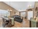 Open-concept space with a dining table and comfortable seating area, plus shuttered windows at 38771 N Dena Dr, San Tan Valley, AZ 85140