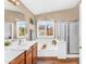Main bathroom featuring a soaking tub, shower, and dual sinks with a view of the outdoors at 38771 N Dena Dr, San Tan Valley, AZ 85140