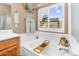 Close up of soaking tub in a well-lit main bathroom with warm paint and fixtures at 38771 N Dena Dr, San Tan Valley, AZ 85140