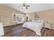 Spacious main bedroom with a vaulted ceiling, wood floors, and view of the backyard pool at 38771 N Dena Dr, San Tan Valley, AZ 85140