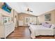 Comfortable main bedroom features wood-look floors, a ceiling fan, and stylish furnishings at 38771 N Dena Dr, San Tan Valley, AZ 85140