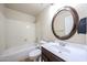 Well-lit bathroom with a white shower-tub combination and a vanity with an oval mirror at 3897 E Douglas Loop, Gilbert, AZ 85234