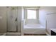 Bright bathroom with a shower enclosure, separate bathtub, and window at 3897 E Douglas Loop, Gilbert, AZ 85234
