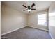 Bedroom with carpet, ceiling fan and window to let the sunlight in, creating a comfortable space at 3897 E Douglas Loop, Gilbert, AZ 85234