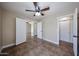 Bedroom featuring tiled floors, ceiling fan, and closet with double doors; great flow to the other rooms at 3897 E Douglas Loop, Gilbert, AZ 85234