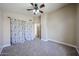 Bedroom with neutral carpet, ceiling fan, closet, and a view of the entrance, combining comfort and convenience at 3897 E Douglas Loop, Gilbert, AZ 85234
