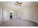 Bright primary bedroom featuring a ceiling fan and openings to the kitchen and bathroom at 3897 E Douglas Loop, Gilbert, AZ 85234