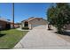A single-story home with a desert landscape, two-car garage, and concrete driveway at 3897 E Douglas Loop, Gilbert, AZ 85234