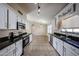 Bright kitchen with stainless steel appliances, white cabinetry, and black granite countertops at 3897 E Douglas Loop, Gilbert, AZ 85234