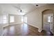 Bright living room with tile floors, ceiling fan, and access to the backyard at 3897 E Douglas Loop, Gilbert, AZ 85234