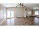 Spacious living room with tile flooring, neutral paint, and a ceiling fan at 3897 E Douglas Loop, Gilbert, AZ 85234