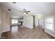Open living room with tile floors, ceiling fan, and seamless flow to kitchen at 3897 E Douglas Loop, Gilbert, AZ 85234