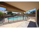 Relaxing backyard featuring a refreshing pool with a safety fence and shaded patio area at 3897 E Douglas Loop, Gilbert, AZ 85234