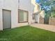 Fully fenced backyard features artificial turf and a small patio area at 4332 E Oakland St, Gilbert, AZ 85295