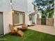 Cozy backyard area with pavers, artificial grass, and string lights, perfect for outdoor relaxation and entertaining at 4332 E Oakland St, Gilbert, AZ 85295