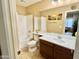 Well-lit bathroom featuring a single vanity, toilet, and shower-tub combination at 4332 E Oakland St, Gilbert, AZ 85295