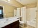 Bright bathroom featuring a shower-tub combo, large mirror, and a single sink vanity at 4332 E Oakland St, Gilbert, AZ 85295