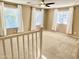 Bright bedroom with carpeted floors, ceiling fan and multiple windows for natural light at 4332 E Oakland St, Gilbert, AZ 85295