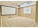 Bonus room is equipped with a projector screen and ceiling fan at 4332 E Oakland St, Gilbert, AZ 85295