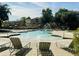 Sparkling community pool with fountains and lounge chairs for residents to enjoy swimming and sunbathing at 4332 E Oakland St, Gilbert, AZ 85295