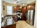 Modern kitchen features stainless steel appliances, dark wood cabinets, and granite countertops at 4332 E Oakland St, Gilbert, AZ 85295