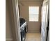 A convenient laundry room with washer, dryer, cabinet, and natural light from the window at 4332 E Oakland St, Gilbert, AZ 85295