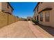 Backyard brick pathway that leads to a fenced gate and desert landscaping at 4644 W Havasupai Dr, Glendale, AZ 85308