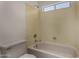 Standard bathtub and shower combination with neutral colored tile surround at 4644 W Havasupai Dr, Glendale, AZ 85308