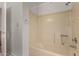 Bathroom shower with handrails and white wall tile at 4644 W Havasupai Dr, Glendale, AZ 85308