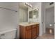 Bathroom vanity with double mirror, wood cabinets, and tile floors at 4644 W Havasupai Dr, Glendale, AZ 85308