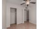 Bright bedroom with ceiling fan, closet, and laminate floors at 4644 W Havasupai Dr, Glendale, AZ 85308