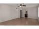 Bedroom featuring light wood floors, a ceiling fan, and bathroom access at 4644 W Havasupai Dr, Glendale, AZ 85308