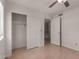 Bedroom featuring light wood floors, a ceiling fan, and closet access at 4644 W Havasupai Dr, Glendale, AZ 85308