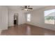 Bright bedroom features light wood floors, a ceiling fan, and ensuite bathroom access at 4644 W Havasupai Dr, Glendale, AZ 85308