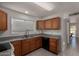 Well-lit kitchen featuring wood cabinets, granite countertops, and stainless steel sink at 4644 W Havasupai Dr, Glendale, AZ 85308