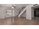 Bright living room featuring a ceiling fan, window with blinds, and staircase at 4644 W Havasupai Dr, Glendale, AZ 85308